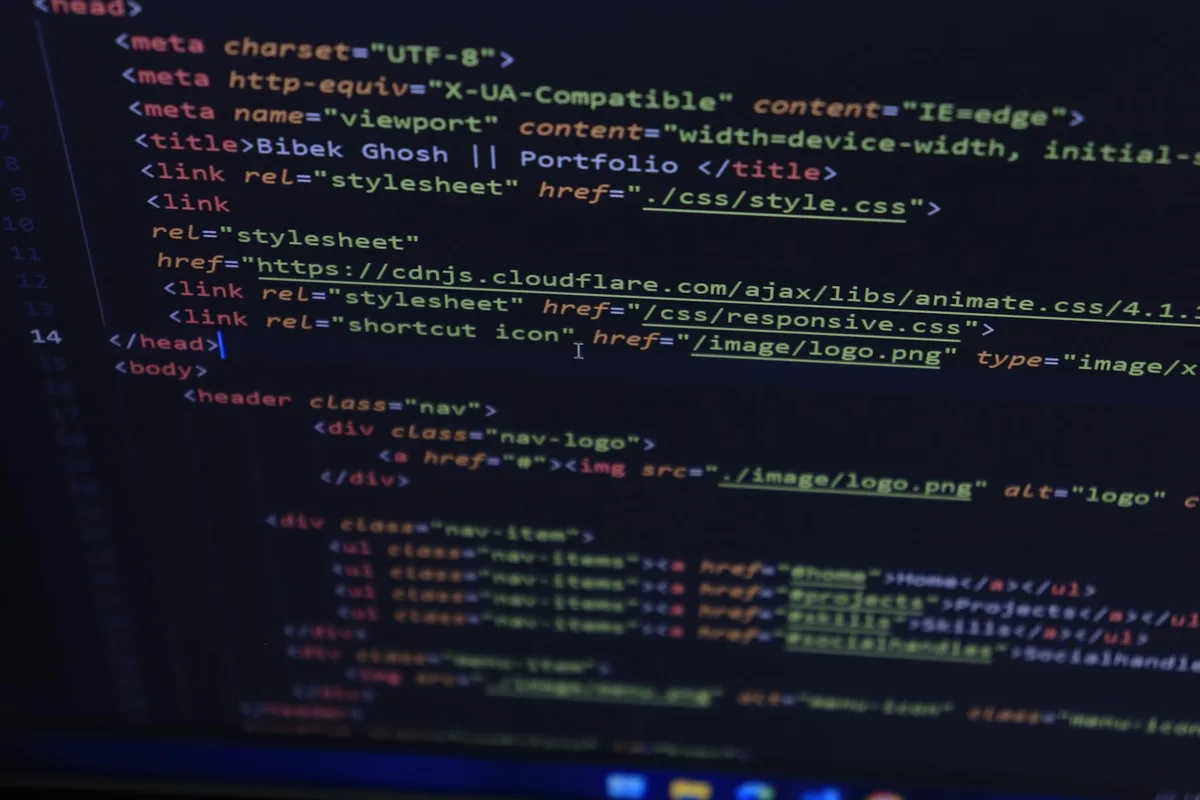 Close-up of HTML/CSS code for a portfolio website with syntax highlighting on a dark editor background