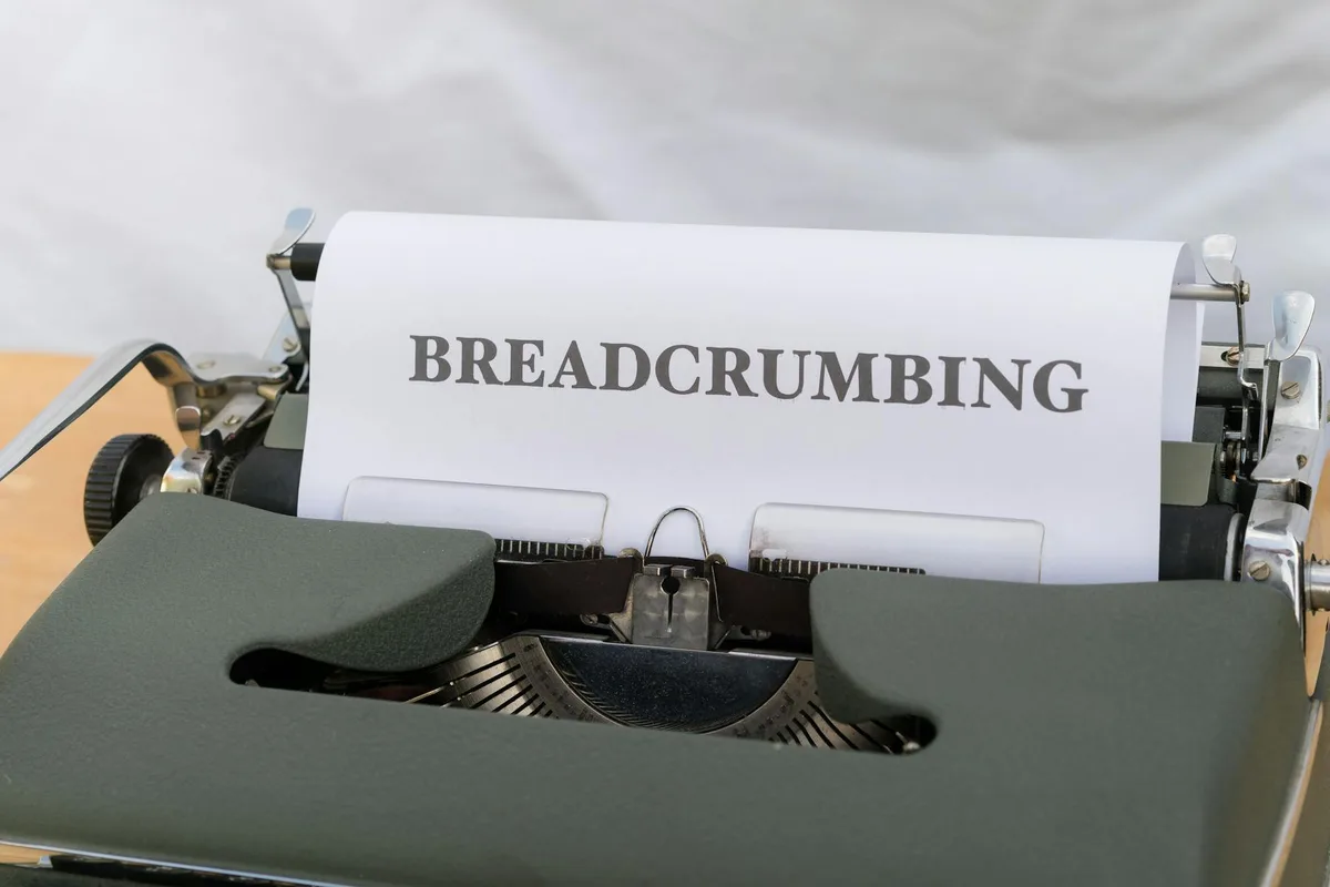 Typewriter with paper showing "BREADCRUMBING" text