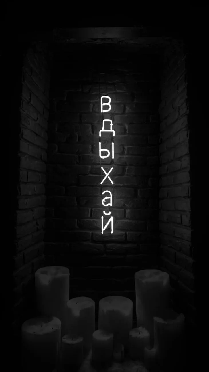 Neon Cyrillic text glowing vertically on dark brick wall with candles below
